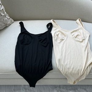 2 size medium bodysuits black and ivory never worn. Price for both bodysuits.NWT